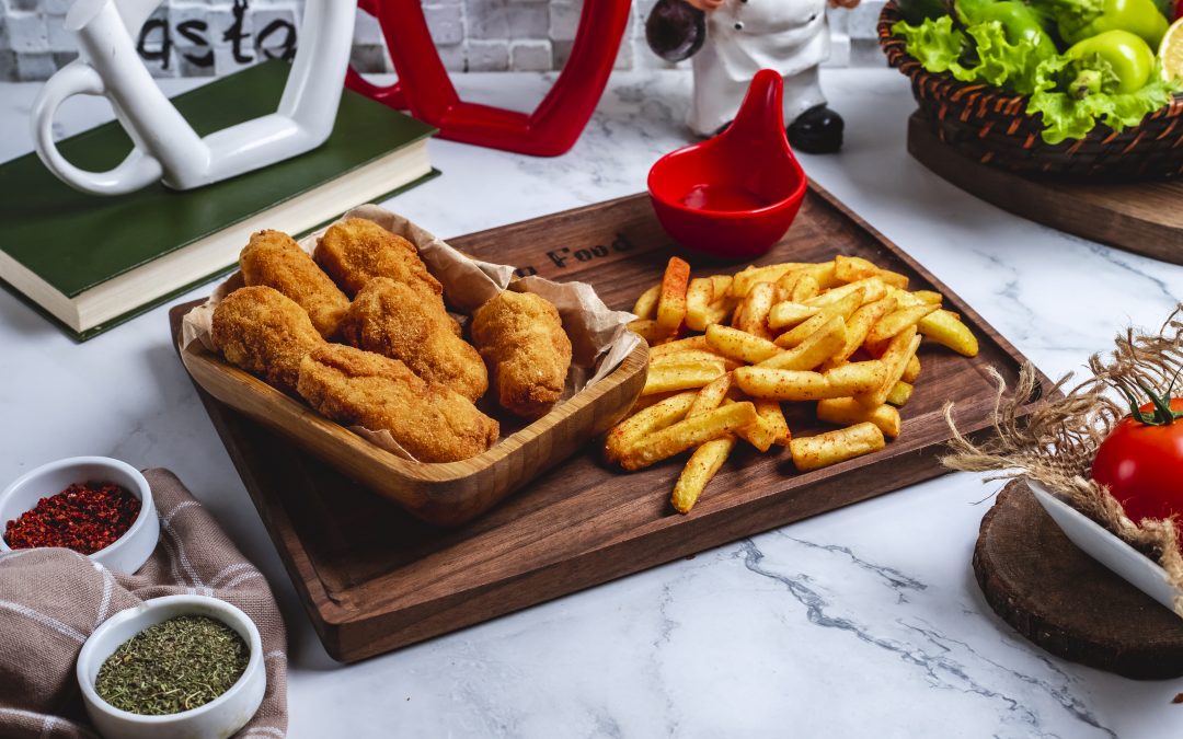 side-view-chicken-nuggets-with-french-fries-ketchup-board